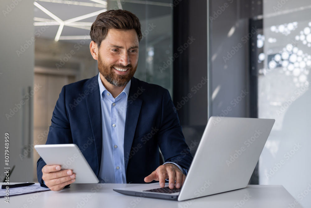 Professional business man working with laptop and tablet Professional business man working with laptop and tablet