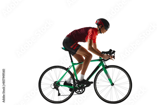 Fototapeta Naklejka Na Ścianę i Meble -  Young man, cycling athlete in sportswear and helmet riding bicycle, training against transparent background. Side view. Concept of sport, action, competition, power and endurance, health, marathon.