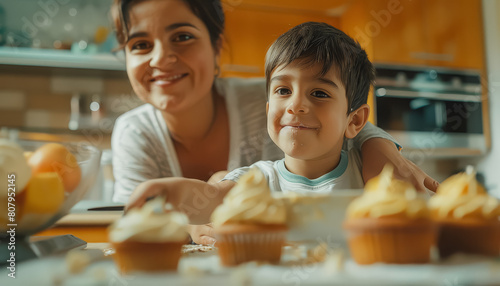 A woman and a child are making cupcakes in a kitchen