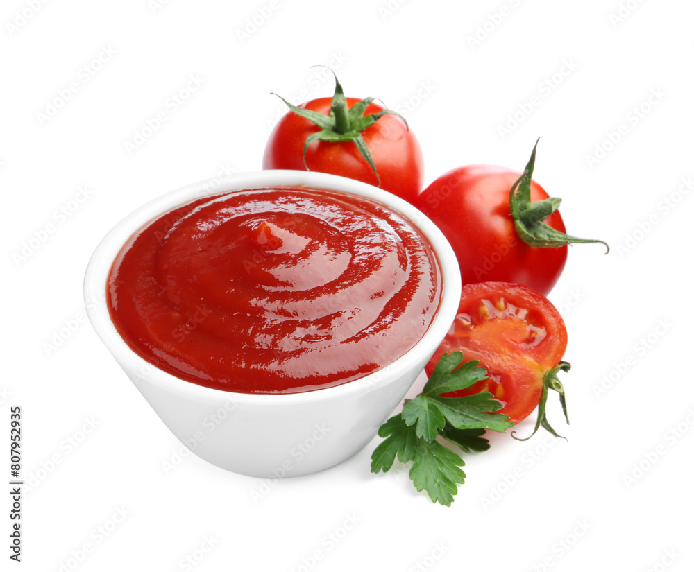 Tasty ketchup in bowl, parsley and fresh tomatoes isolated on white Tasty ketchup in bowl, parsley and fresh tomatoes isolated on white