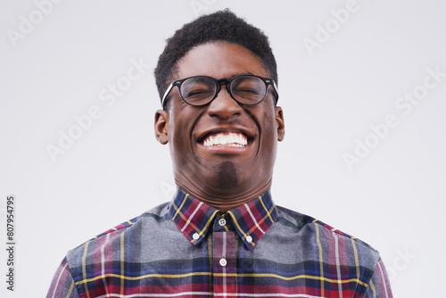 African man, playful and crazy face in studio for emoji, comedy and fun by white background. Black male person, emotions and silly for joke, prank and comic for humour and laugh isolated on backdrop