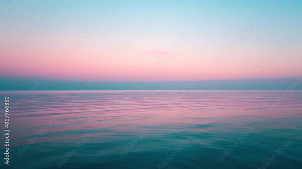 The subtle glow of twilight captured on a serene lake, with the light softly transitioning from blue to pink at the horizon