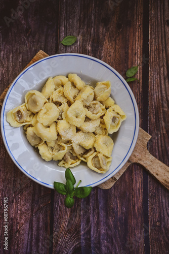 Home made vegetarian  italian   Tortellini with pesto genovese filled with   spinach   and parmesan cheese, decorated with fresh basil
