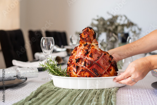 placing christmas ham on the table photo