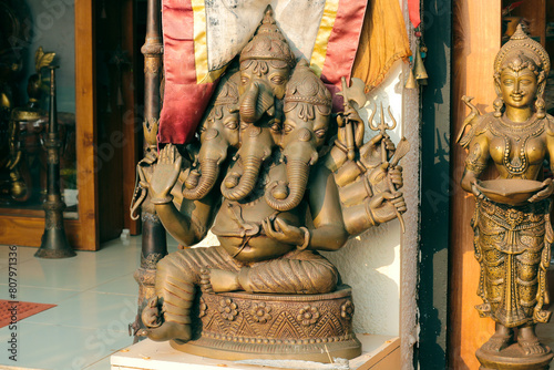 Bronze multi-armed and multi-headed Ganesha and Deepa Lakshmi.