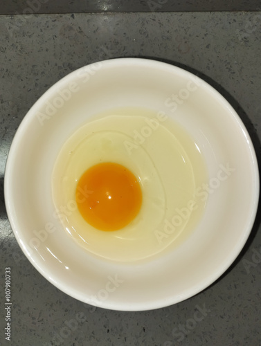 raw egg in a white bowl