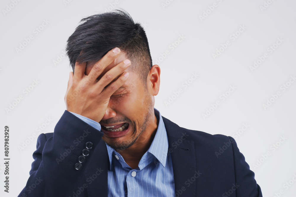 Crying, stress or sad businessman in studio with loss, depression or debt risk on grey background. Pain, sorrow or emotional Asian banker frustrated by fear, worry or grief with anxiety or bad news Crying, stress or sad businessman in studio with loss, depression or debt risk on grey background. Pain, sorrow or emotional Asian banker frustrated by fear, worry or grief with anxiety or bad news