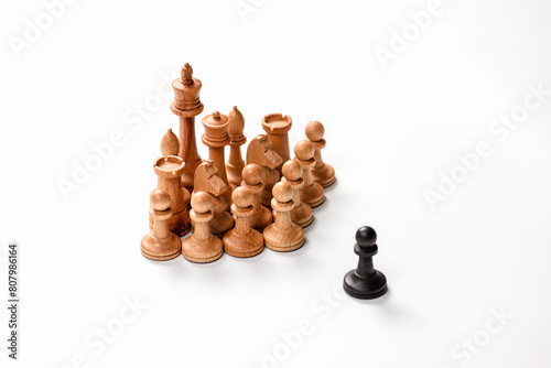 The chess piece is black pawn against white pieces. Business concept and decision strategies.