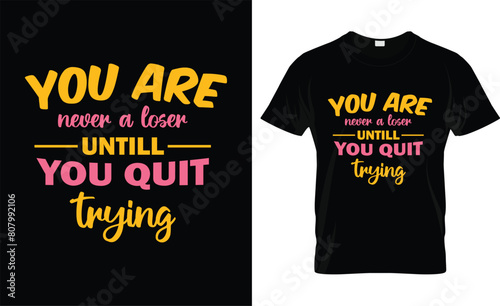 Motivational black t-shirt featuring bold yellow text proclaiming 'YOU ARE never a loser UNTIL YOU QUIT trying'.
