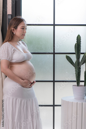 woman holding belly. woman holding her belly and holding her belly. Pregnant woman gently holding her bally. photo