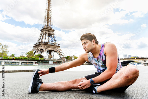 Man training and doing fitness exercises along the Seine river in Paris