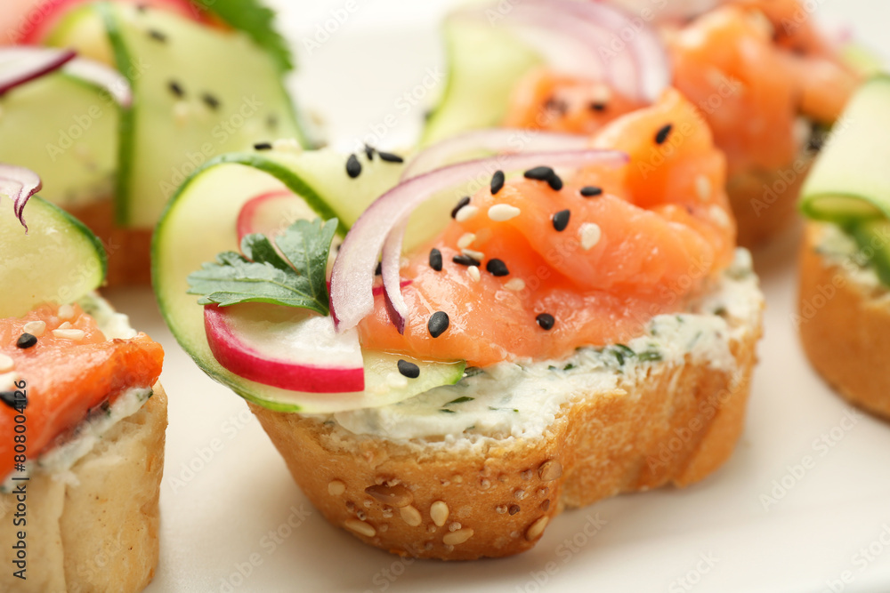 Tasty canapes with salmon served on table, closeup Tasty canapes with salmon served on table, closeup