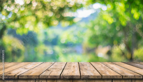 green leaf bokeh blurred and wood table for nature background