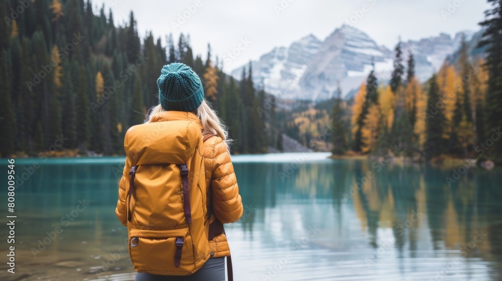A woman with a yellow backpack looking at the water, AI