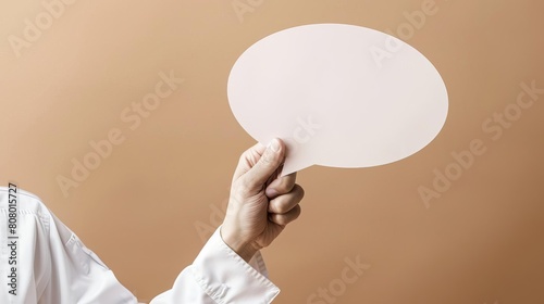 A chef s hand, clean and professional, holding a speech bubble against a culinarythemed background of soft brown, suitable for recipes or cooking tips photo