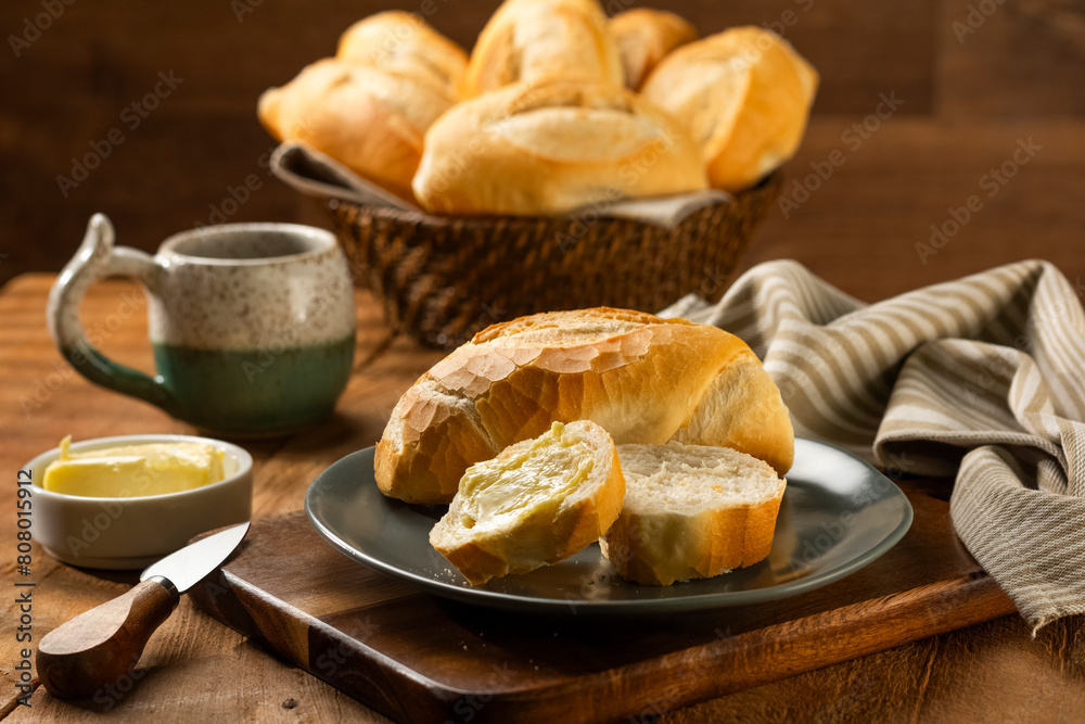 French bread in the basket with butter and rustic background