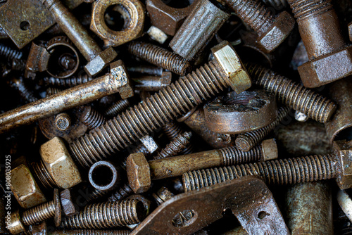 Pile of rustic nuts and bolts in grease,Close-up of a nut with oil stains,