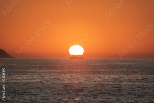 Sunset in the sea with navy ship