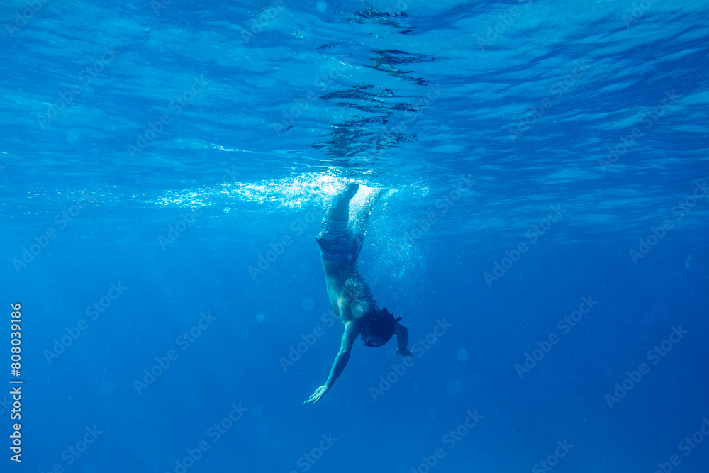 View of Young Person Underwater Getting in the Ocean with Snorkel.Copy Space