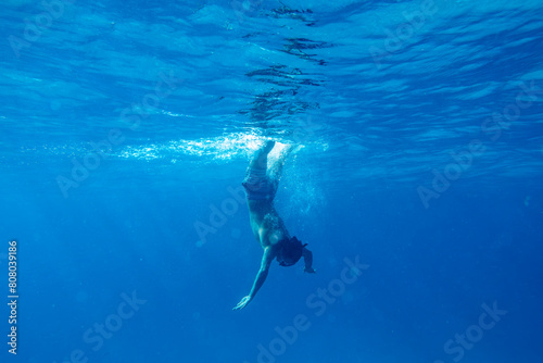 View of Young Person Underwater Getting in the Ocean with Snorkel.Copy Space
