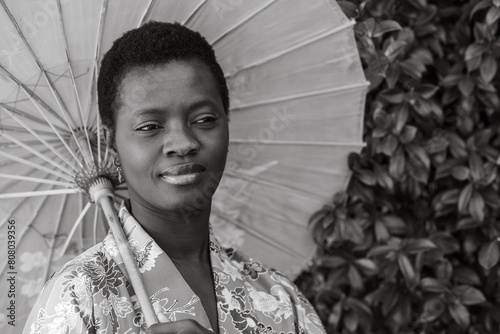 monochome portrait of young adult short haired african woman dressed in vintage kimono and parasol photo