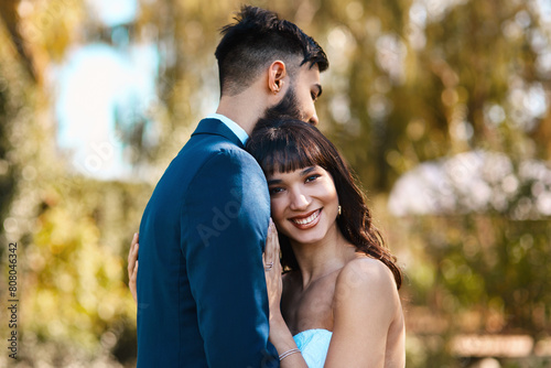 Couple, portrait and hug on wedding in nature, happy and commitment for marriage or relationship. People, embrace and countryside in outdoor ceremony, partnership and celebration of love or bonding