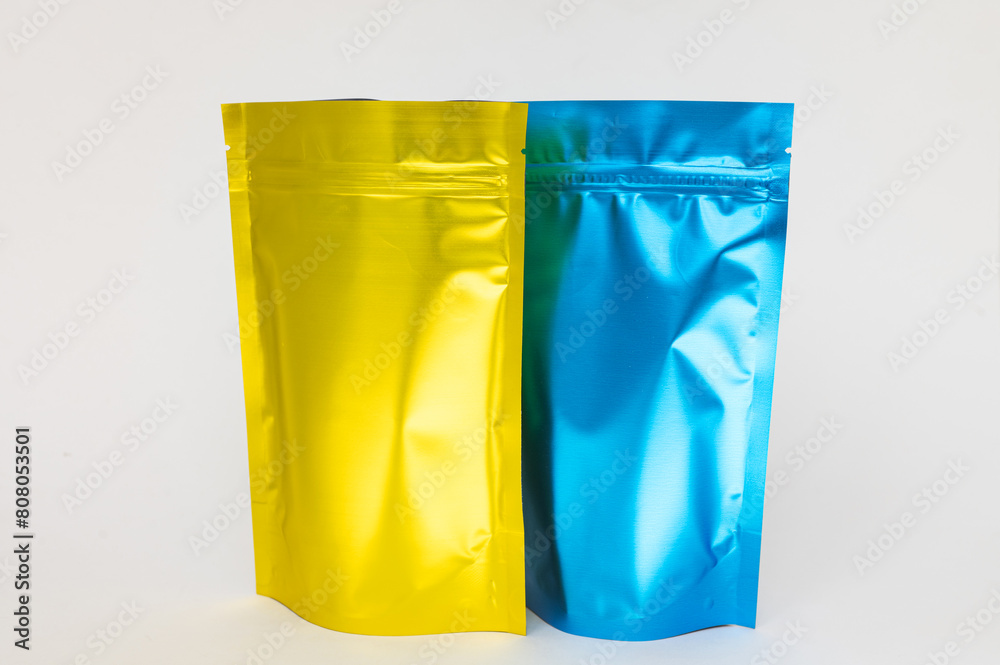 Gold and blue metal bag with a lock, side view with a highlighted shadow on a white background. Gold and blue metal bag with a lock, side view with a highlighted shadow on a white background.