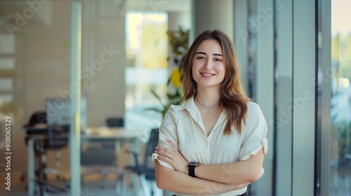 Portrait of young smiling woman looking at camera with crossed arms Happy girl standing in creative office Successful businesswoman standing in office with copy space : Generative AI Free Download Portrait of young smiling woman looking at camera with crossed arms Happy girl standing in creative office Successful businesswoman standing in office with copy space : Generative AI - GFXLoad