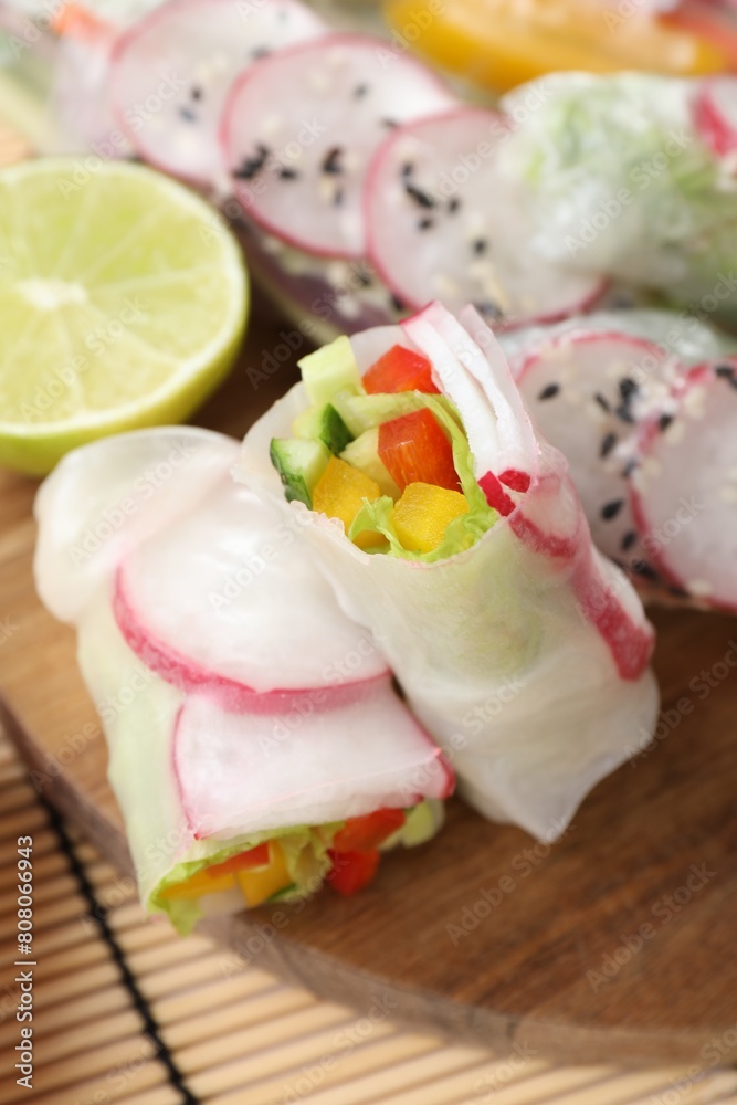 Delicious spring rolls and lime on table, closeup Delicious spring rolls and lime on table, closeup
