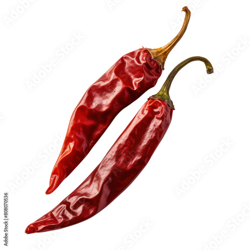 A pair of dried red chili peppers isolated on a black background. photo