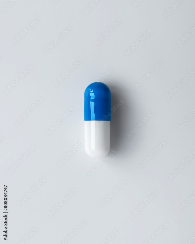 White and blue capsule top view close-up White and blue capsule top view close-up