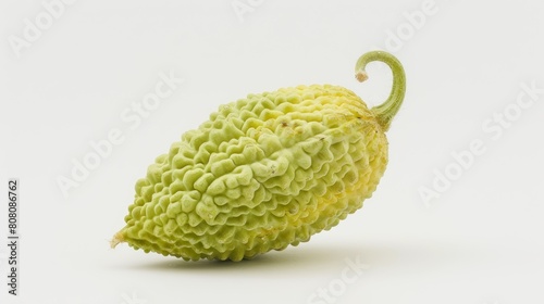 A single bitter melon with its distinctive warty texture, prominently displayed against a white background to highlight its unique shape photo