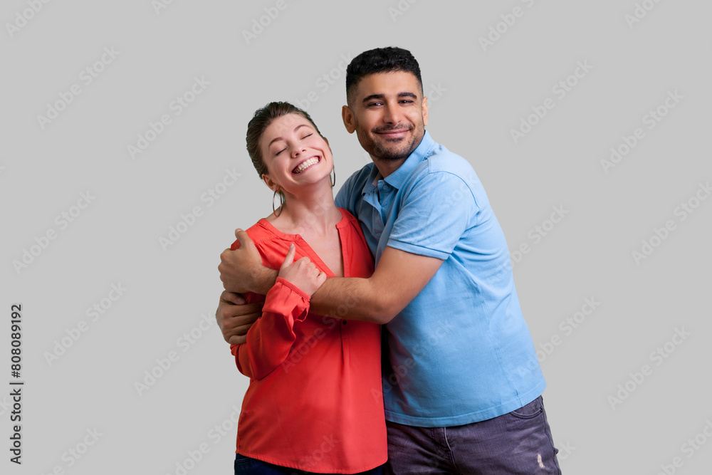 Φωτογραφία Portrait of happy optimistic family couple standing together hugging each other expressing love and gentle feelings looking at camera
