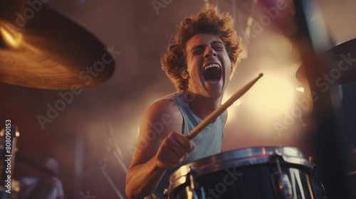 A close-up shot of a drummer's intense expression as they pound on their kit at a music festival