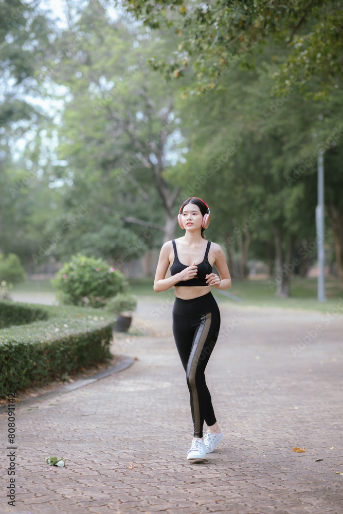 Asian woman exercising in the park Her gaze was determined to lose weight. The concept of healthy lifestyle activities Asian woman exercising in the park Her gaze was determined to lose weight. The concept of healthy lifestyle activities