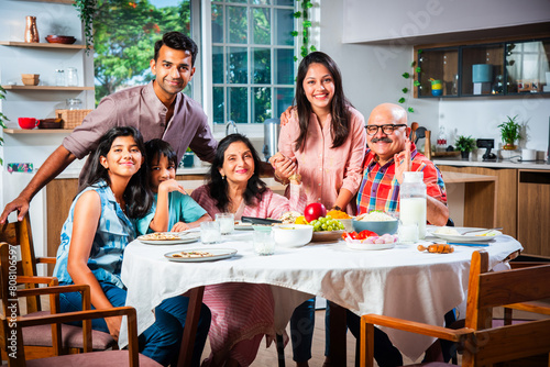 Photography Happy Indian asian family having lunch at home and posing for photo