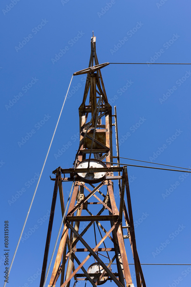 Abandoned metal tower structure in mountain landscape of Asturias Spain on a bright day Abandoned metal tower structure in mountain landscape of Asturias Spain on a bright day