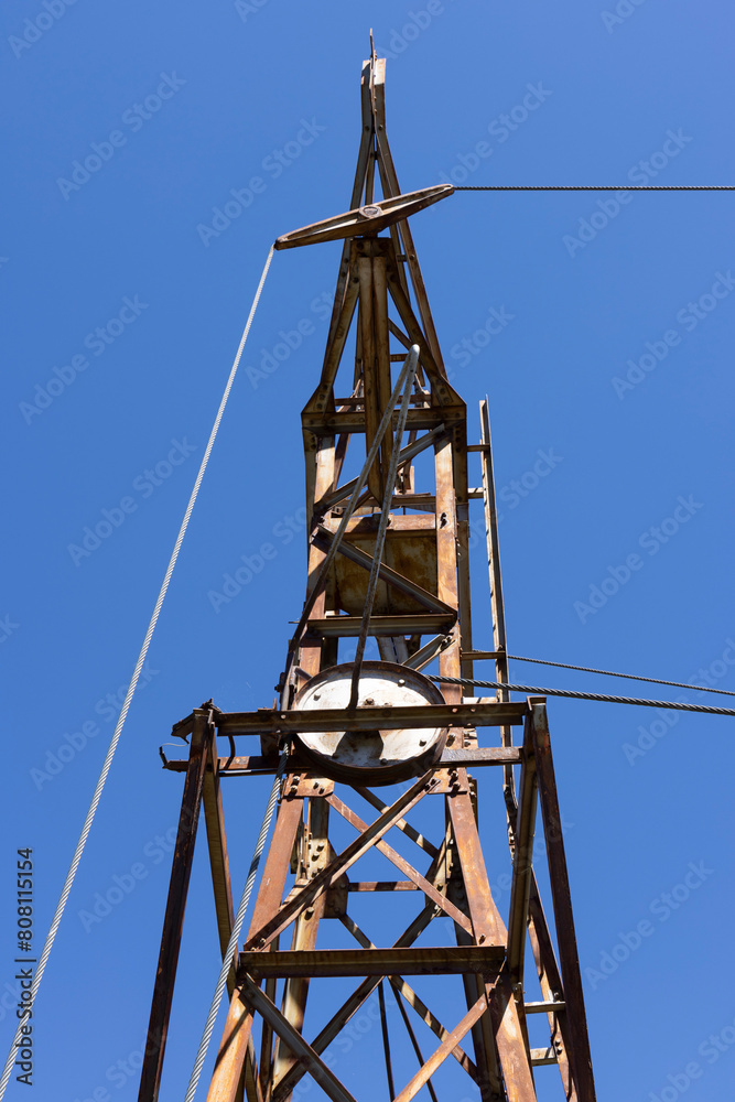 Abandoned metal tower structure in mountain landscape of Asturias Spain on a bright day Abandoned metal tower structure in mountain landscape of Asturias Spain on a bright day