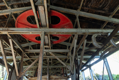 Steel metal wheel in industrial coal mining factory building with beams in Tormaleo Asturias. photo