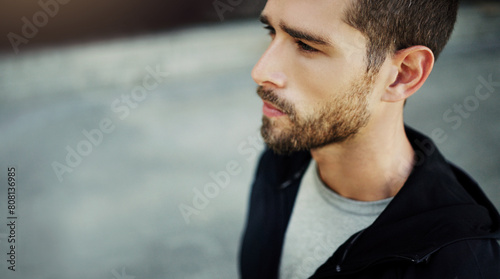 Man, runner and thinking in urban outdoor for health, sports training and wellness with running exercise. Serious male person, thoughtful and workout in city with fitness ideas, mindfulness and beard
