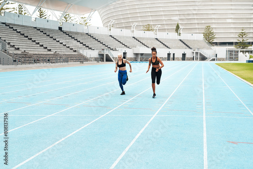 Woman, athletes and running at stadium for fitness, exercise and training, speed and endurance for marathon race. People, active and field for sport with energy, power and activity for competition