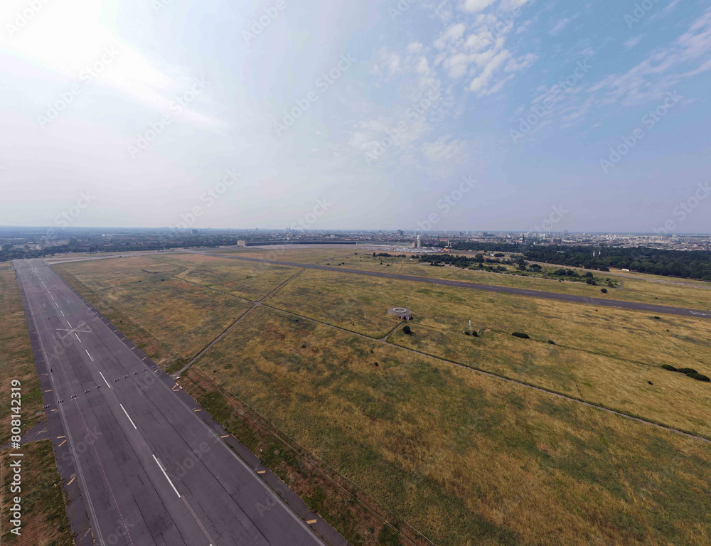 Aerial landscape of Tempelhofer Feld runway at abandoned airport in summer in Central Berlin Aerial landscape of Tempelhofer Feld runway at abandoned airport in summer in Central Berlin
