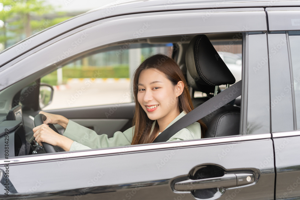 Transport, happy smile brunette hair asian young woman hand holding steering wheel driving car, vehicle for travel trip, sits on driver seat, female with fasten safety seat belt before traveling.