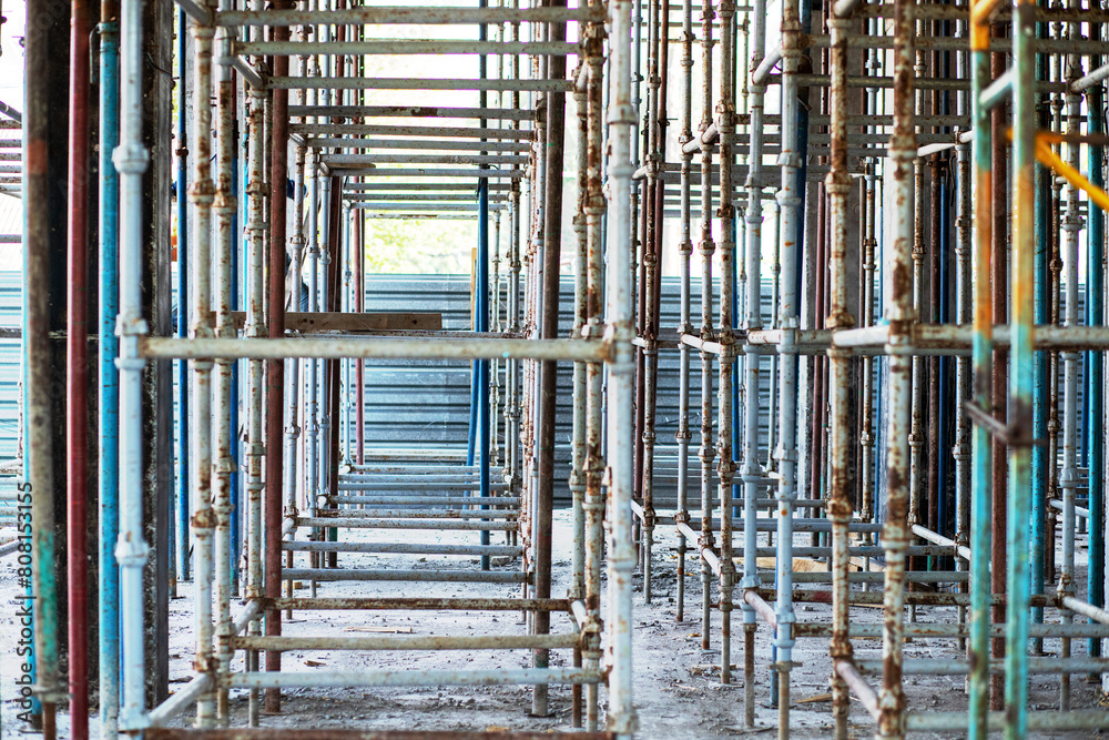 Exposed scaffolding under the ceiling for pouring concrete at a construction site.