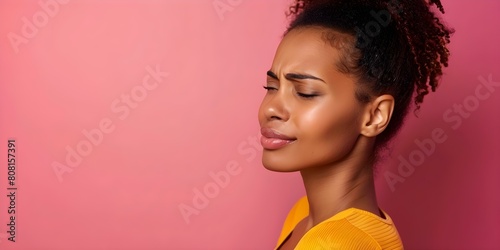African American woman with back pain and spinal disc herniation on pink background. Concept Medical Conditions, African American Women, Back Pain, Spinal Disc Herniation, Pink Background