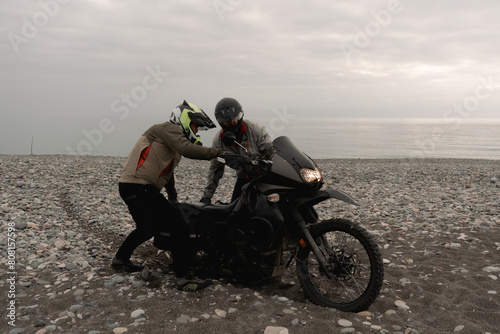 Wallpaper Mural Friends bikers helping in trip on adventure motorcycle towing on sea shore pebbles Torontodigital.ca