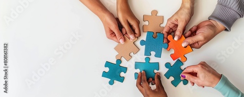 A group of people are holding a puzzle together. The puzzle is colorful and has a circular shape. photo