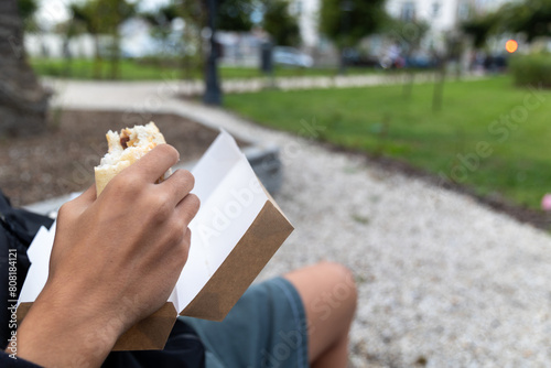 Person eating a squid sandwich