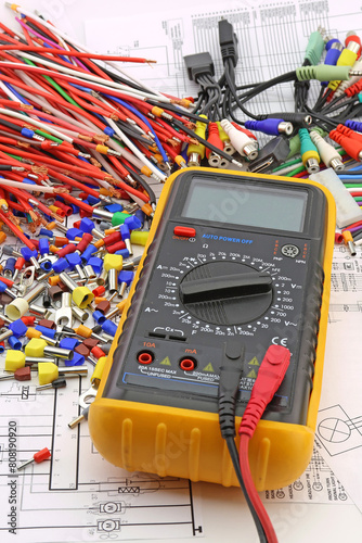A digital multimeter for measuring the parameters of electrical circuits in an electrical diagram. Close-up.