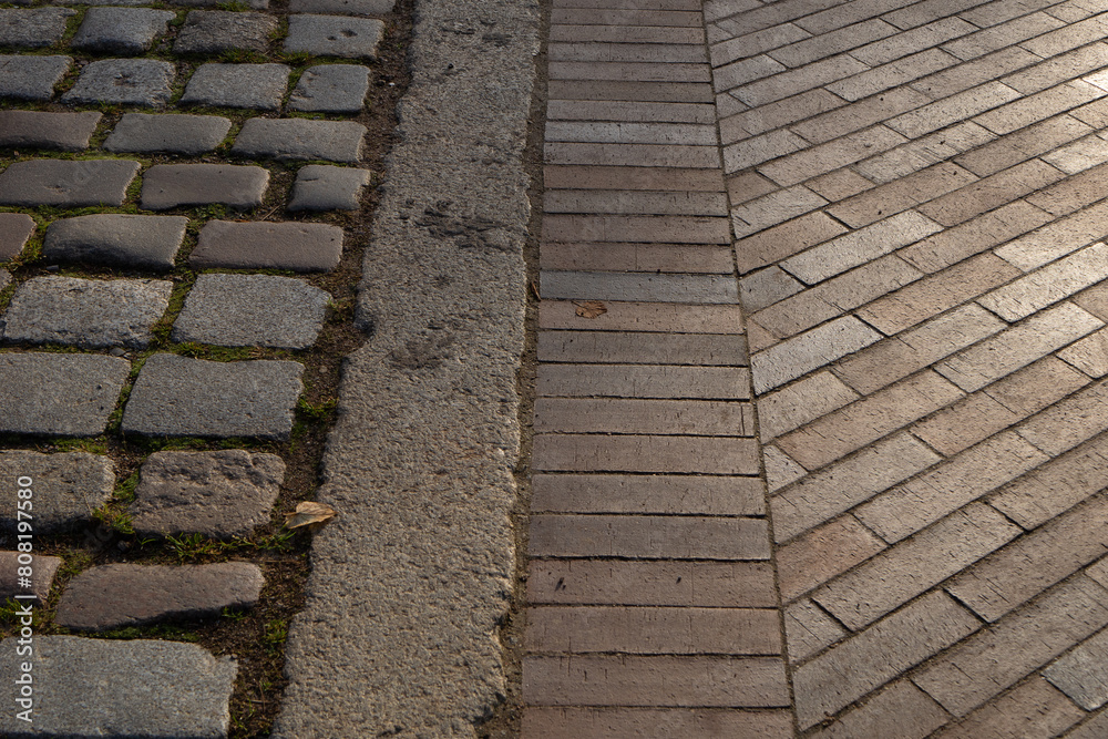 The pavement area is paved with gray large stones and tiles texture